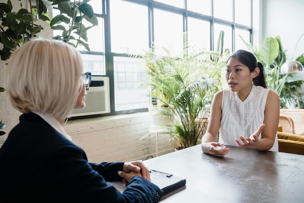 photo two people talking at a table